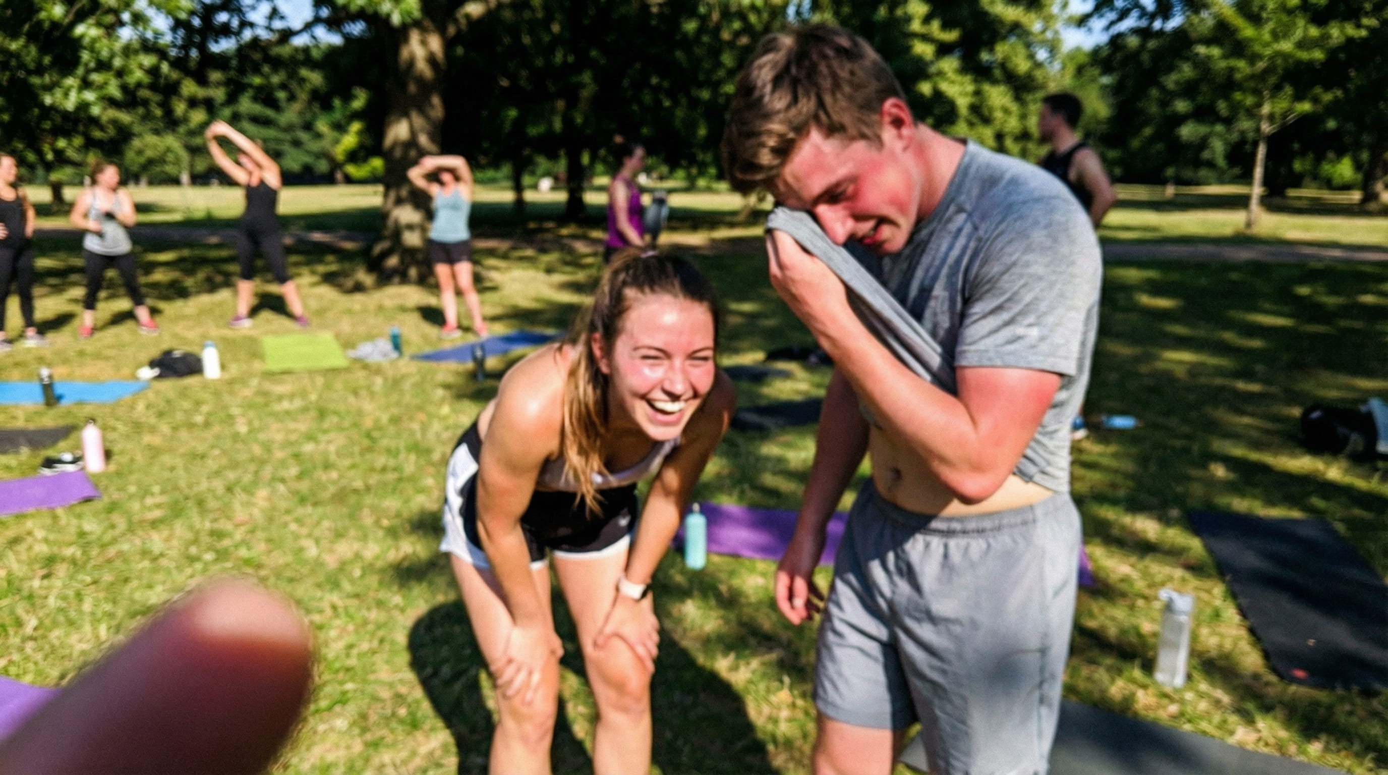 Young couple laughing together after an outdoor fitness class
